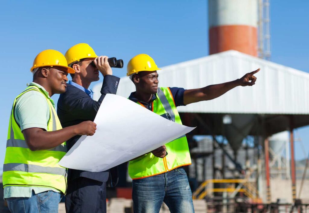 Allen Power Limited engineers reviewing plans on a power plant construction site